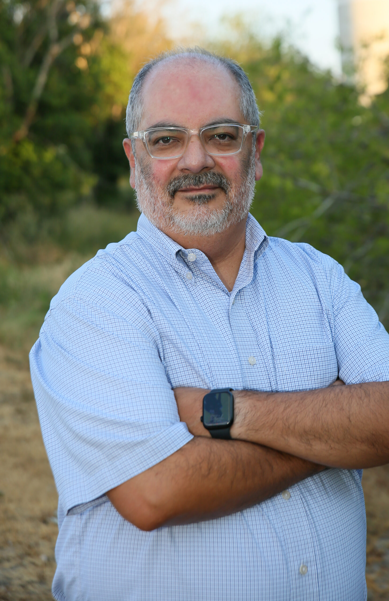 Emilio Silvas standing by Converse TX water tower